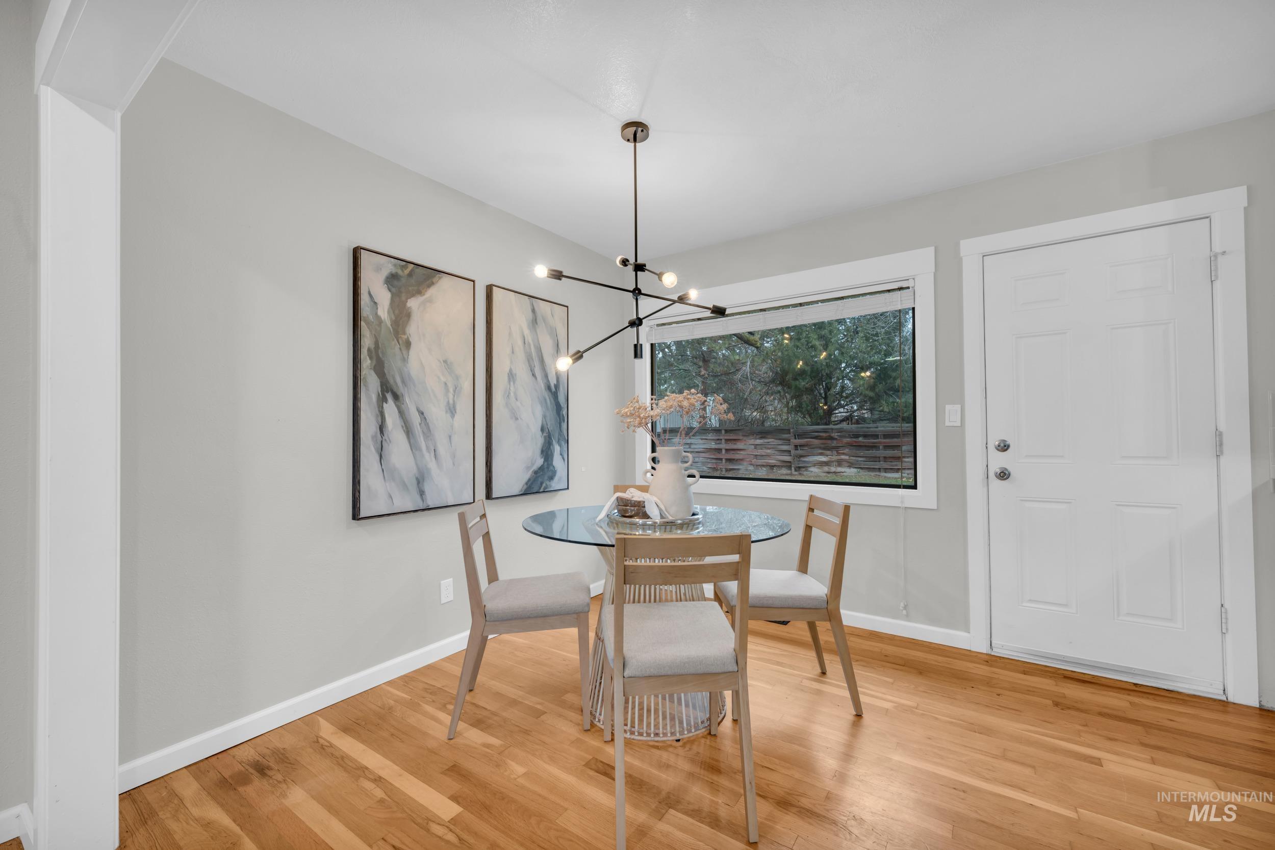 2908 Meadowbrook Drive Boise, ID 83705 - Photo 10 of 29 Dining space with light wood-style flooring and a chandelier