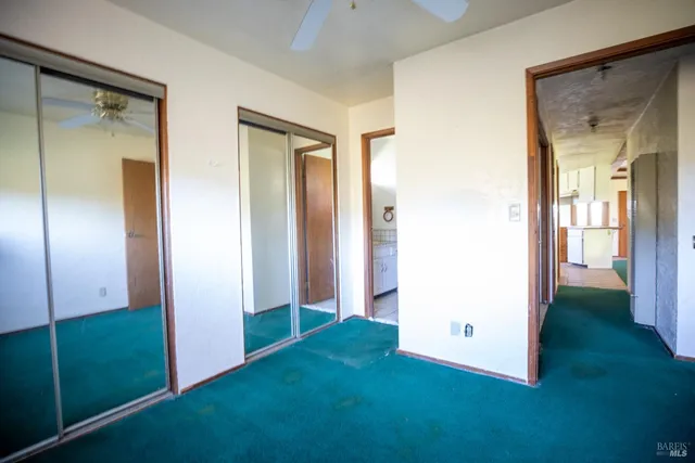 a bathroom with a granite countertop sink toilet a mirror and shower
