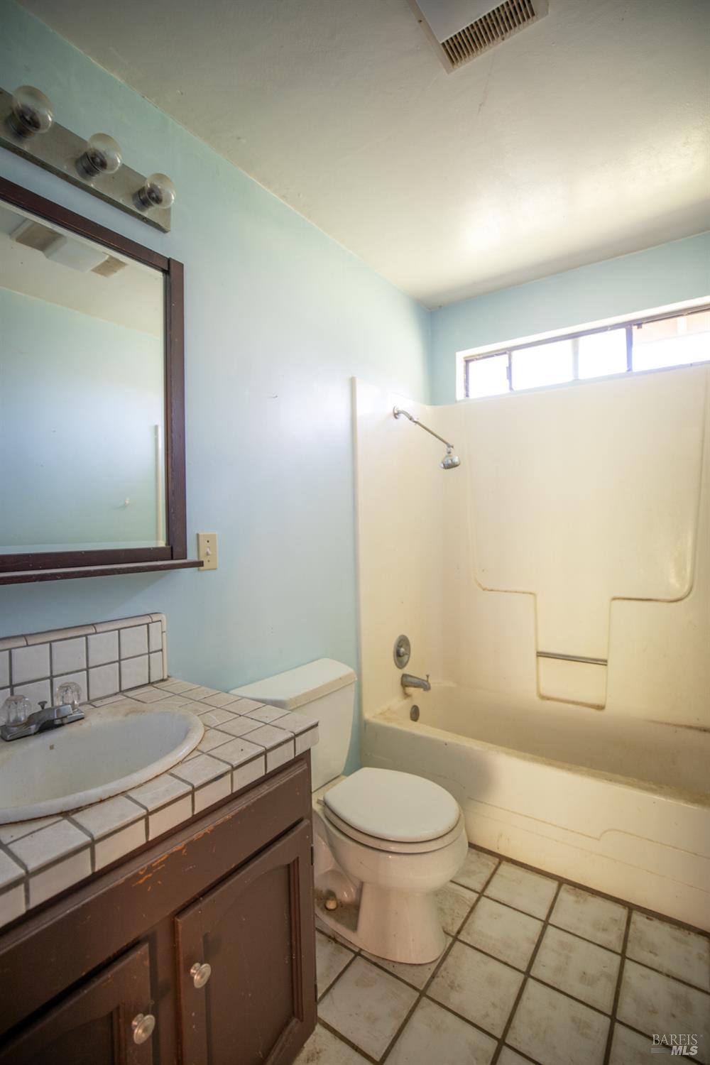 2300 Brack Road Healdsburg, CA 95448 - Photo 14 of 41 a bathroom with a granite countertop sink toilet a mirror and shower