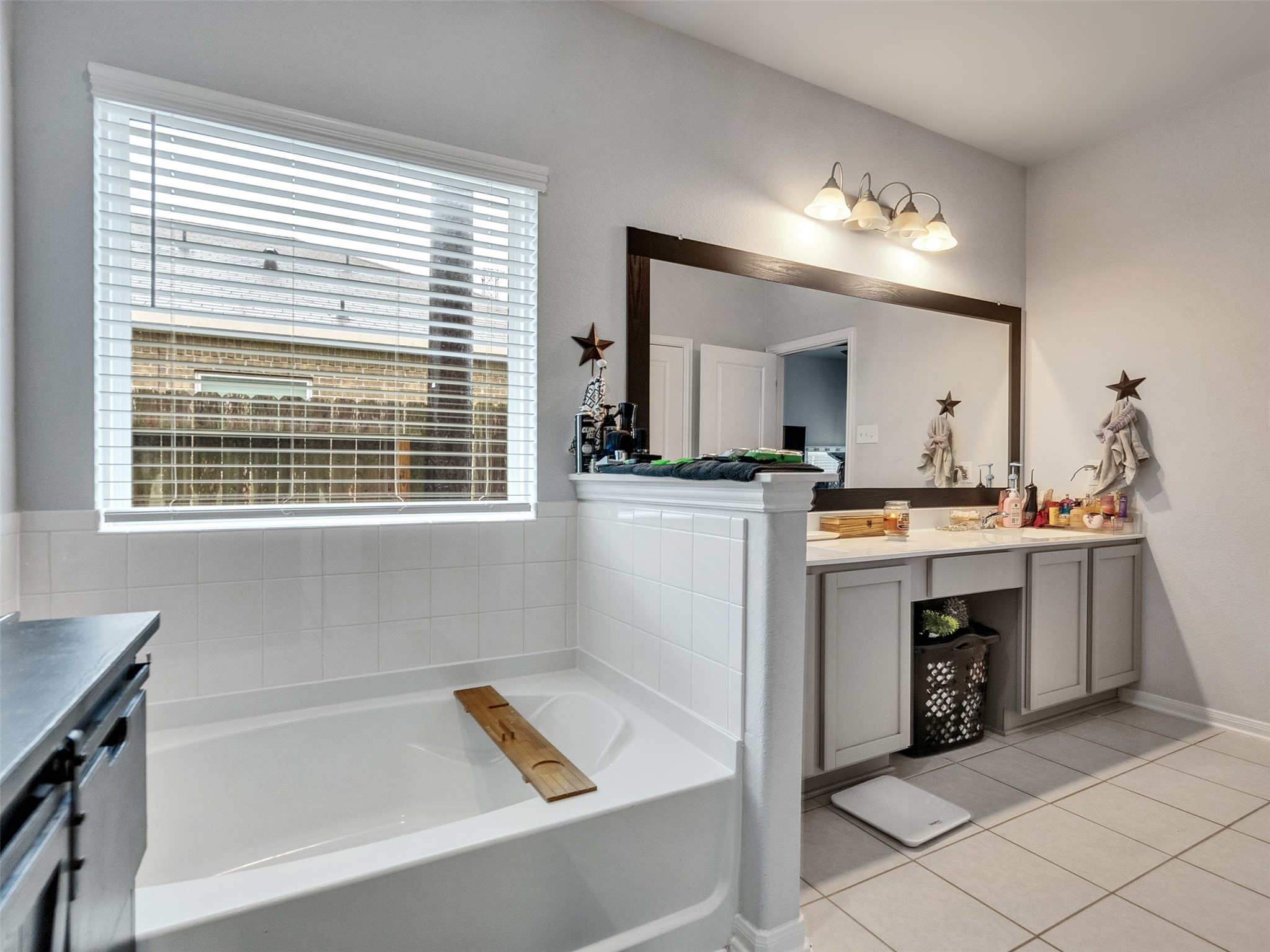 8719 Willet Street Baytown, TX 77521 - Photo 38 of 42 a bathroom with a sink a large mirror and a bathtub