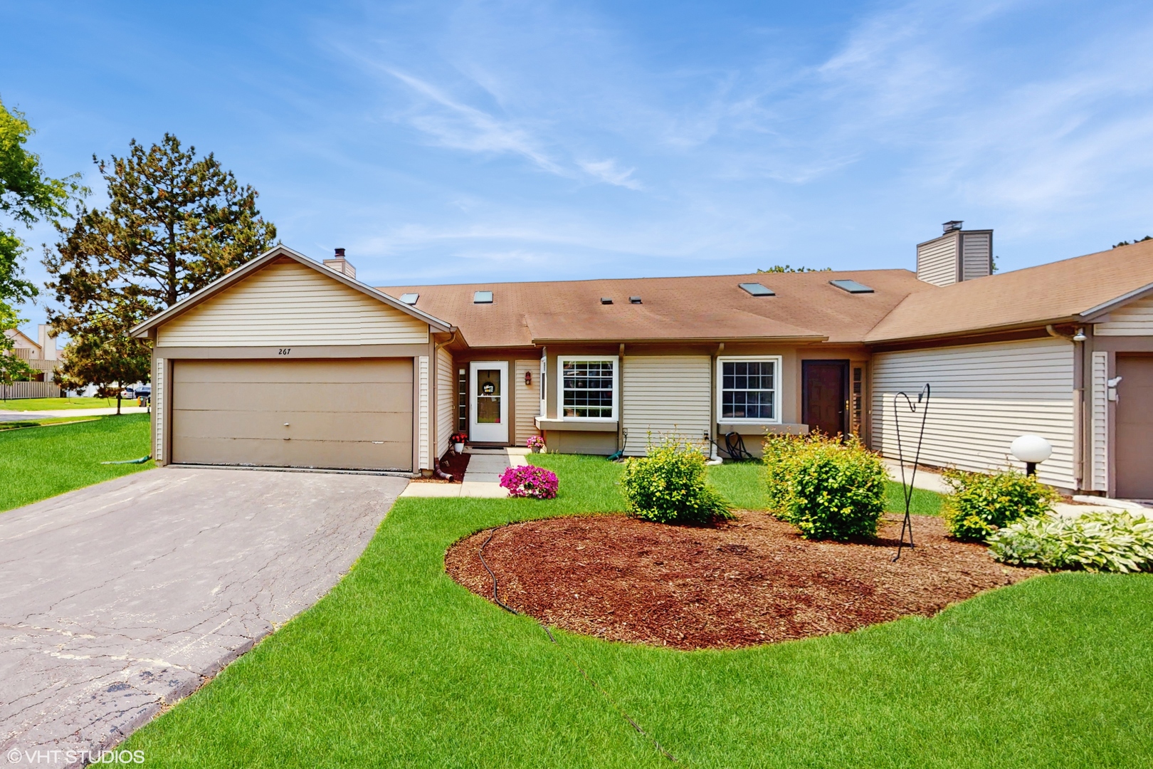 267 Juniper Circle Streamwood, IL 60107 - Photo 1 of 25 a front view of a house with a yard and garage