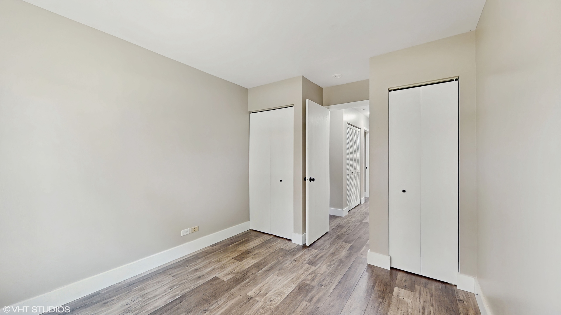 267 Juniper Circle Streamwood, IL 60107 - Photo 17 of 25 a view of an empty room with wooden floor and a bathroom