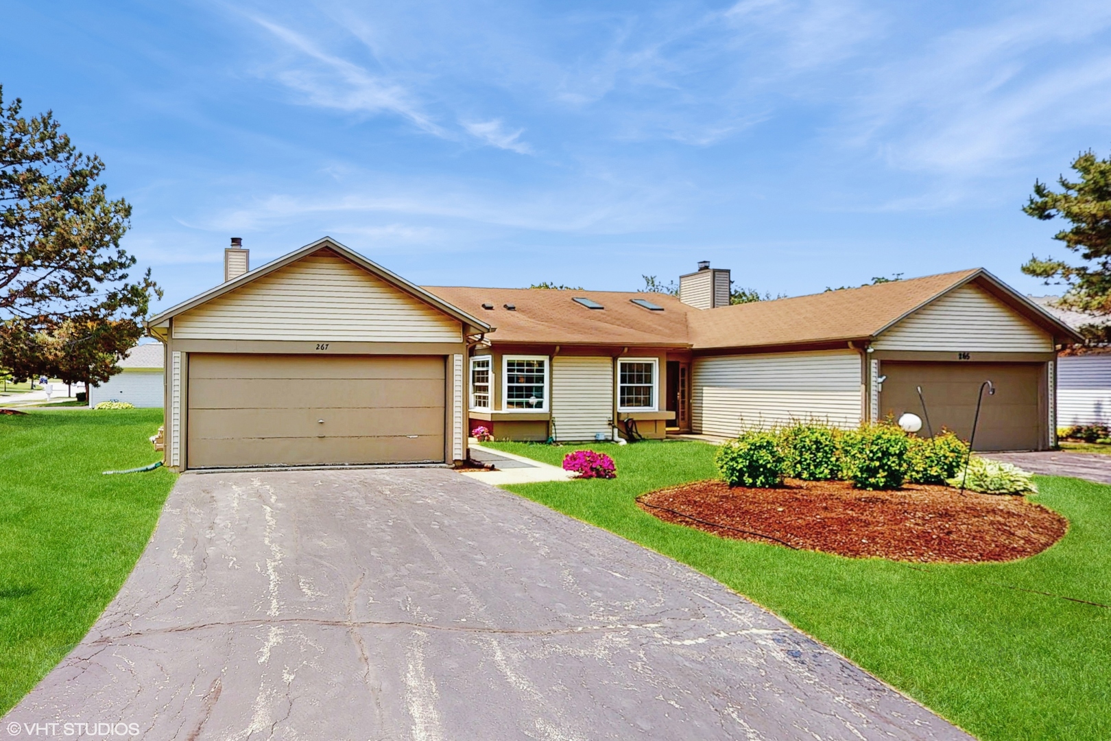 267 Juniper Circle Streamwood, IL 60107 - Photo 2 of 25 a front view of a house with a yard and garage