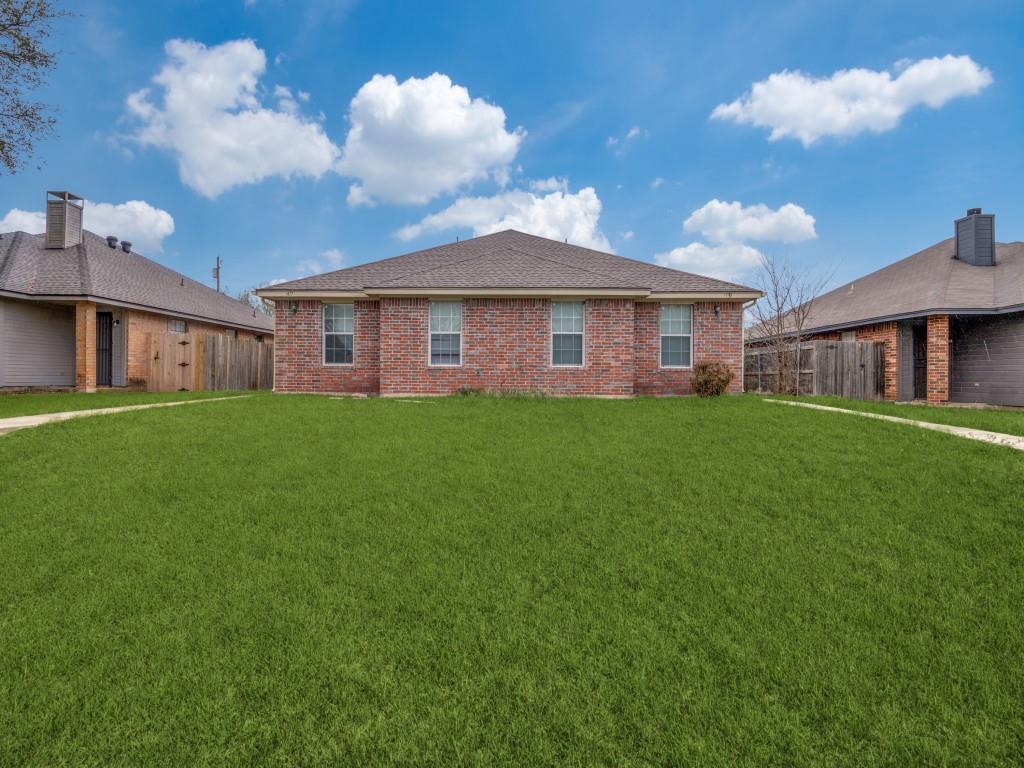 1439 North Bluegrove Road Lancaster, TX 75134 - Photo 1 of 12 a view of a house with a yard and a garden