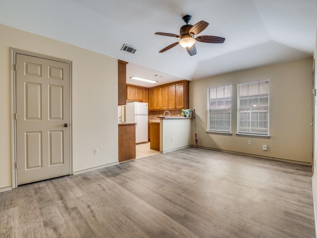 1439 North Bluegrove Road Lancaster, TX 75134 - Photo 2 of 12 a view of a kitchen with a stove cabinets a ceiling fan and wooden floor