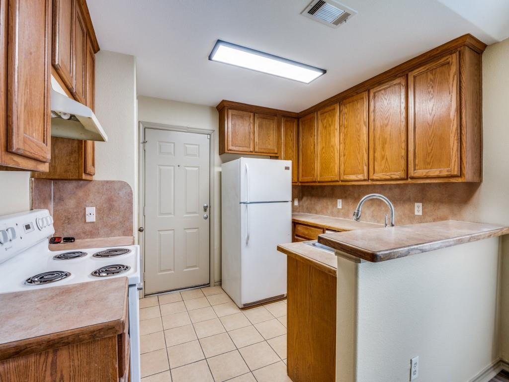 1439 North Bluegrove Road Lancaster, TX 75134 - Photo 4 of 12 a kitchen with stainless steel appliances granite countertop a sink stove and refrigerator