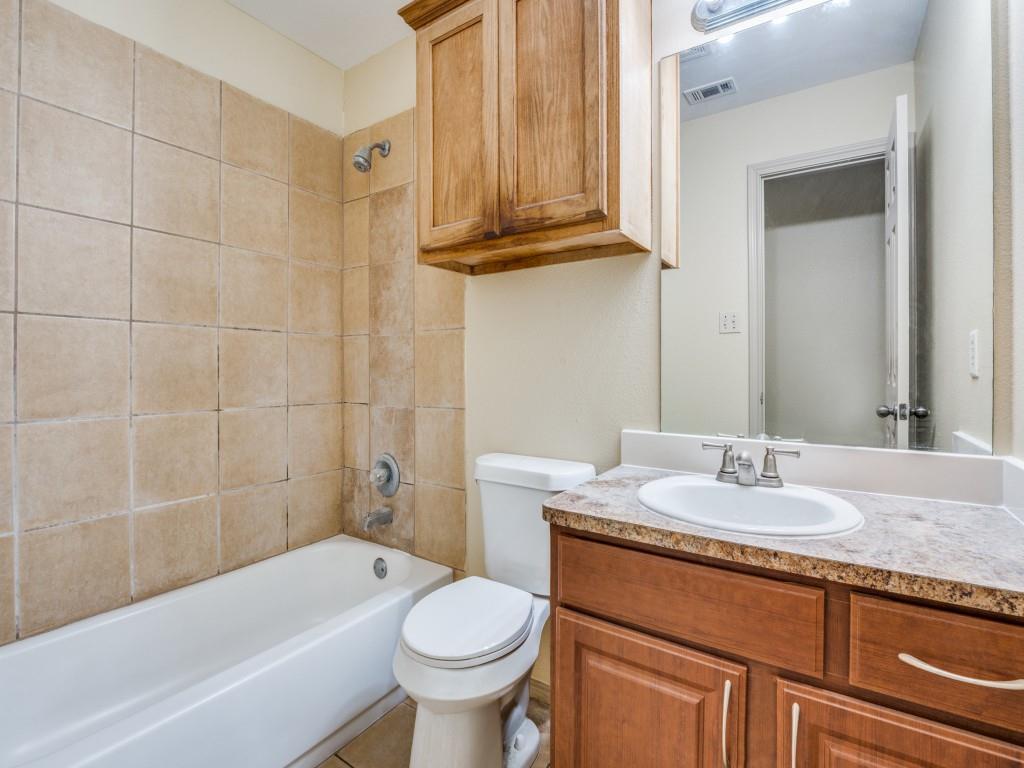 1439 North Bluegrove Road Lancaster, TX 75134 - Photo 8 of 12 a bathroom with a granite countertop sink a toilet and bathtub