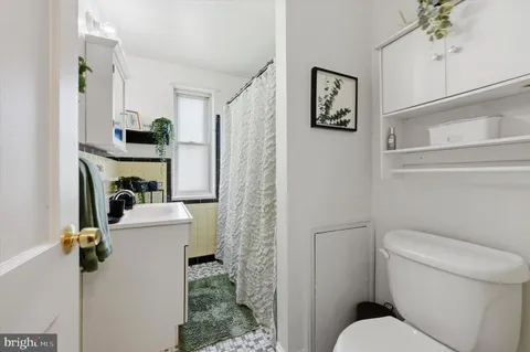 a bathroom with a toilet sink and shower