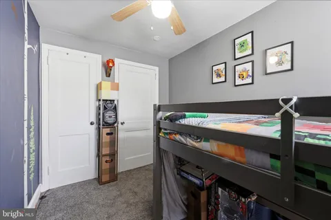 a view of a bedroom with a bed and a bookshelf