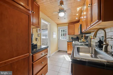 a kitchen with stainless steel appliances granite countertop a sink and a refrigerator