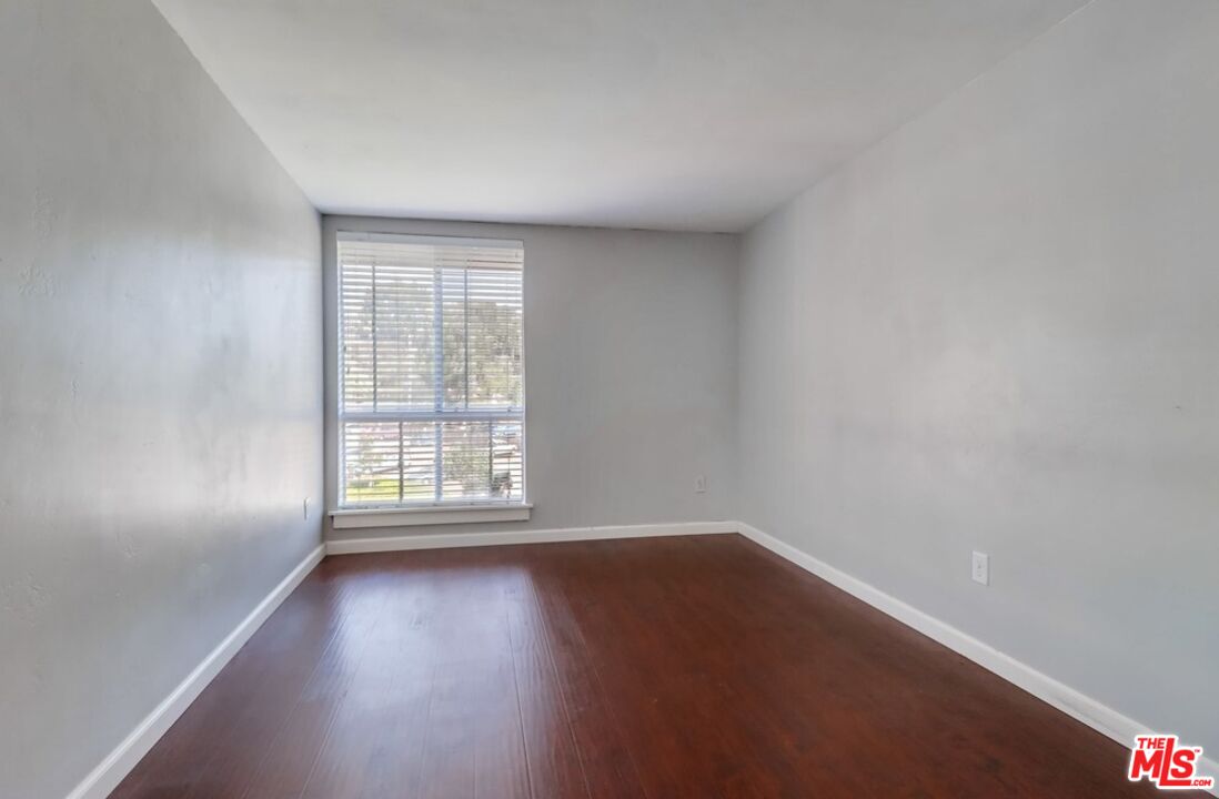 6171 Rancho Mission Road, Unit 317 San Diego, CA 92108 - Photo 11 of 26 wooden floor in an empty room with a window