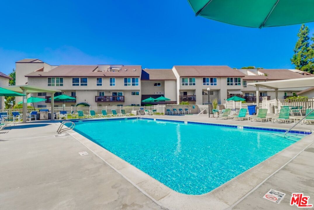 6171 Rancho Mission Road, Unit 317 San Diego, CA 92108 - Photo 23 of 26 a building view with a swimming pool and outdoor seating