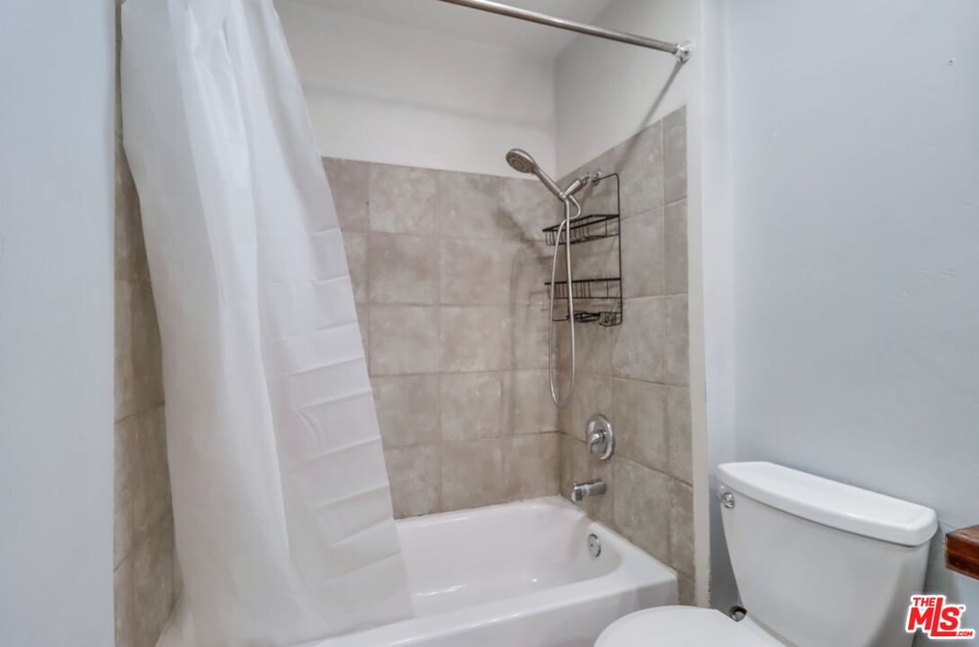 6171 Rancho Mission Road, Unit 317 San Diego, CA 92108 - Photo 8 of 26 a bathroom with a shower and a toilet
