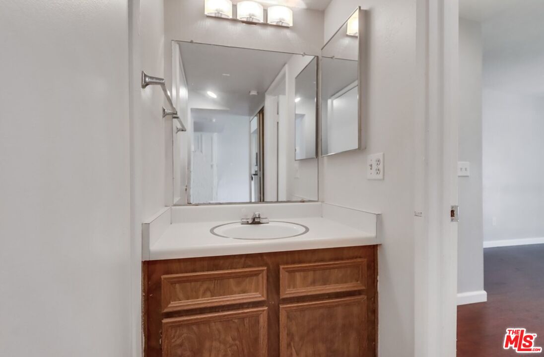 6171 Rancho Mission Road, Unit 317 San Diego, CA 92108 - Photo 10 of 26 a bathroom with a sink and a mirror