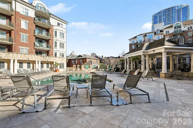 a view of a patio with a table and chairs and potted plants