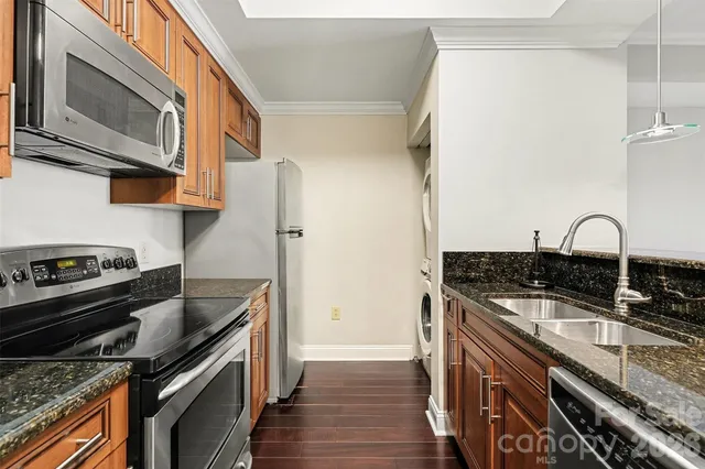 a kitchen with granite countertop a stove and a sink