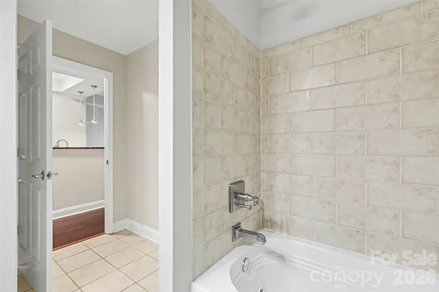 a bathroom with a tub shower and sink
