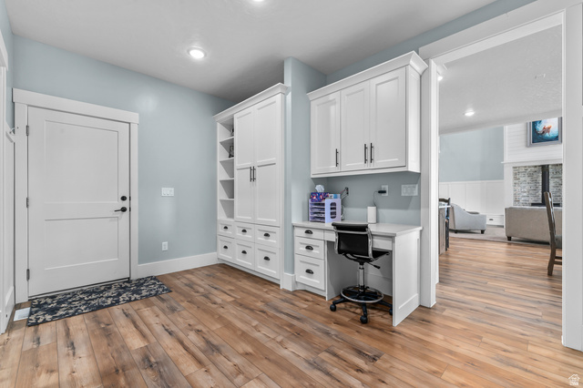 1426 South 1450th Street West Mapleton, UT 84664 - Photo 11 of 50 Entryway featuring wood-finish flooring, a white paneled door, recessed lighting, and a built-in desk with overhead cabinetry