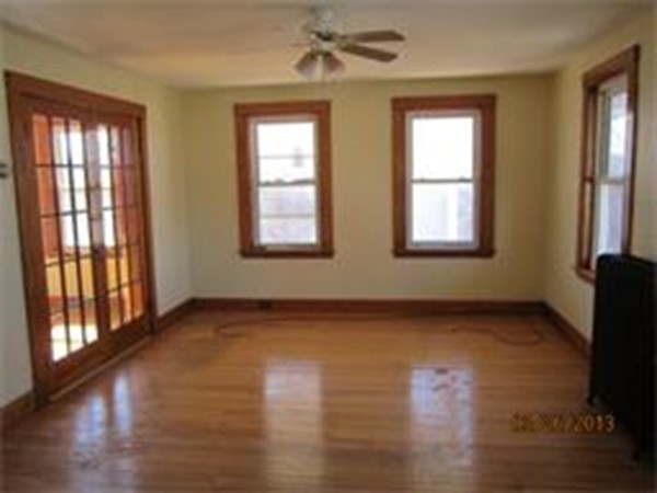 22 Riverside Avenue Gloucester, MA 01930 - Photo 4 of 13 a view of an empty room with wooden floor and a window