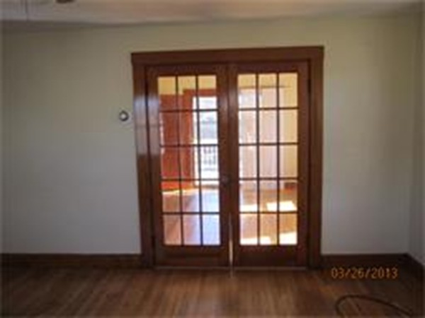 22 Riverside Avenue Gloucester, MA 01930 - Photo 6 of 13 an empty room with wooden floor and windows