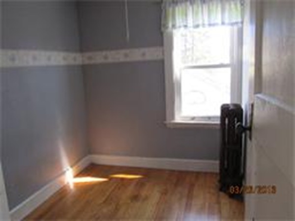 22 Riverside Avenue Gloucester, MA 01930 - Photo 9 of 13 a view of a room with wooden floor and a window
