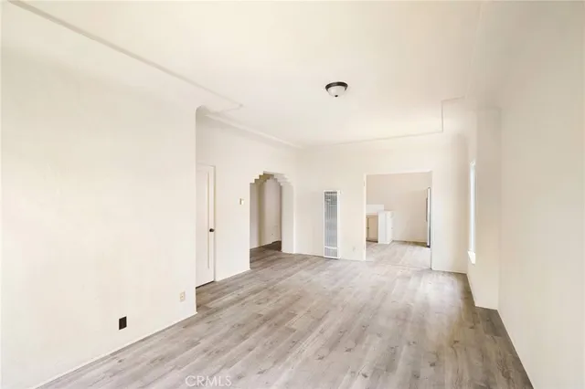 a view of a room with wooden floor