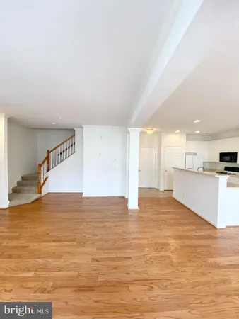 a kitchen with a sink a counter top space stainless steel appliances and cabinets