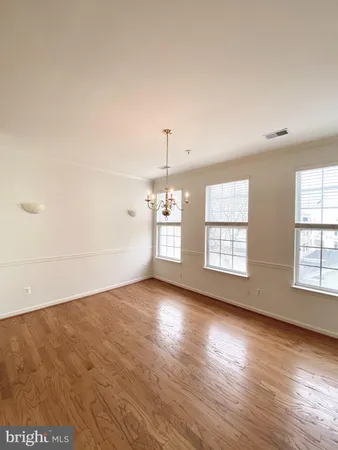 a kitchen with granite countertop a refrigerator sink and cabinets
