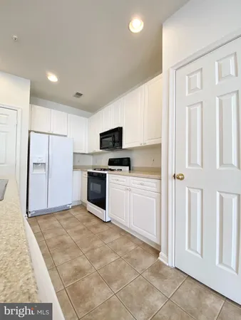 a kitchen with granite countertop a sink and cabinets