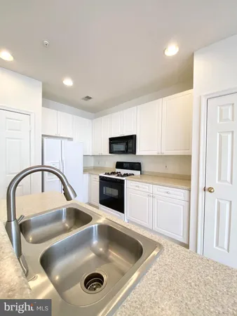 a kitchen with sink and cabinets