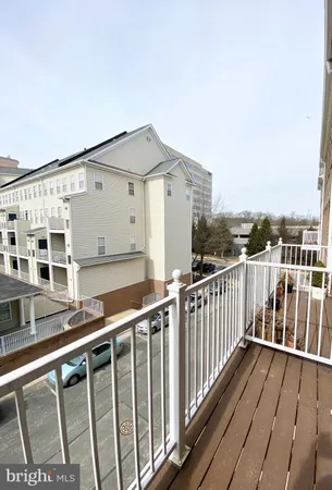 an empty room with windows and ceiling fan