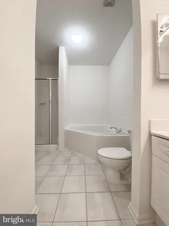 a bath tub sitting next to a white toilet