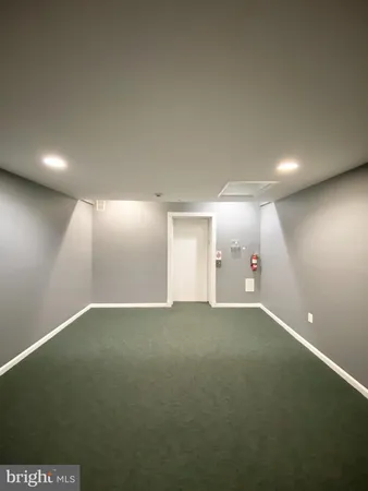 a view of empty room with wooden floor and fireplace
