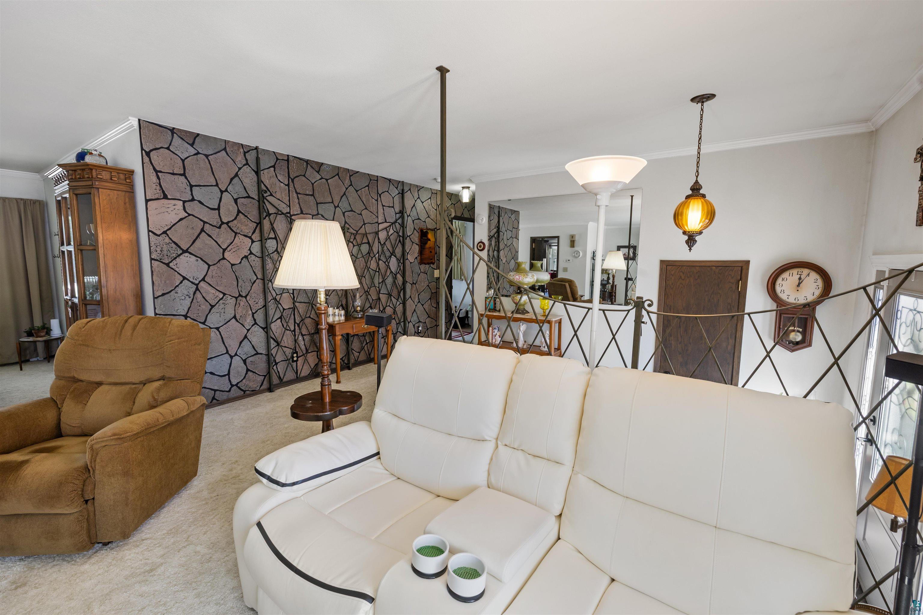 3975 Long Lake Shores Road Eveleth, MN 55734 - Photo 11 of 79 Carpeted living area featuring an accent wall and ornamental molding