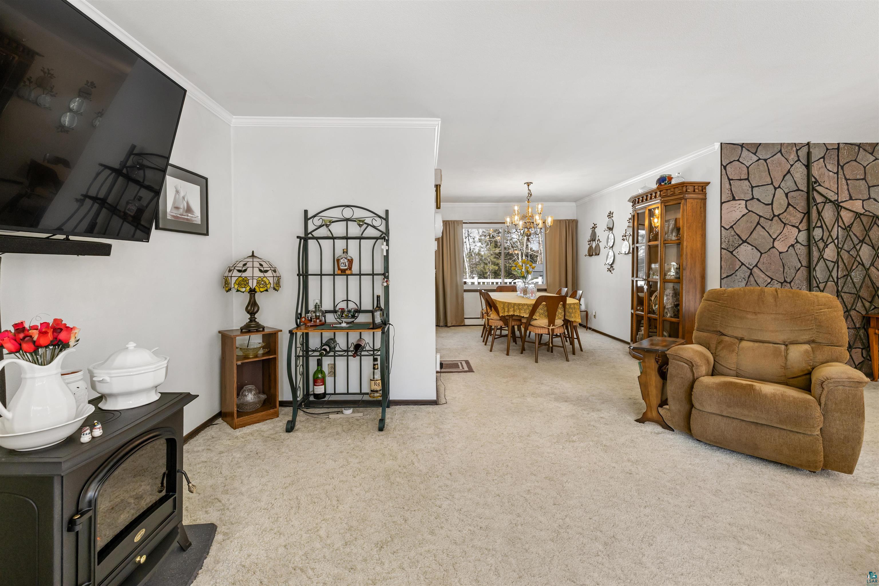 3975 Long Lake Shores Road Eveleth, MN 55734 - Photo 12 of 79 Sitting room with light colored carpet, crown molding, and suspended lighting