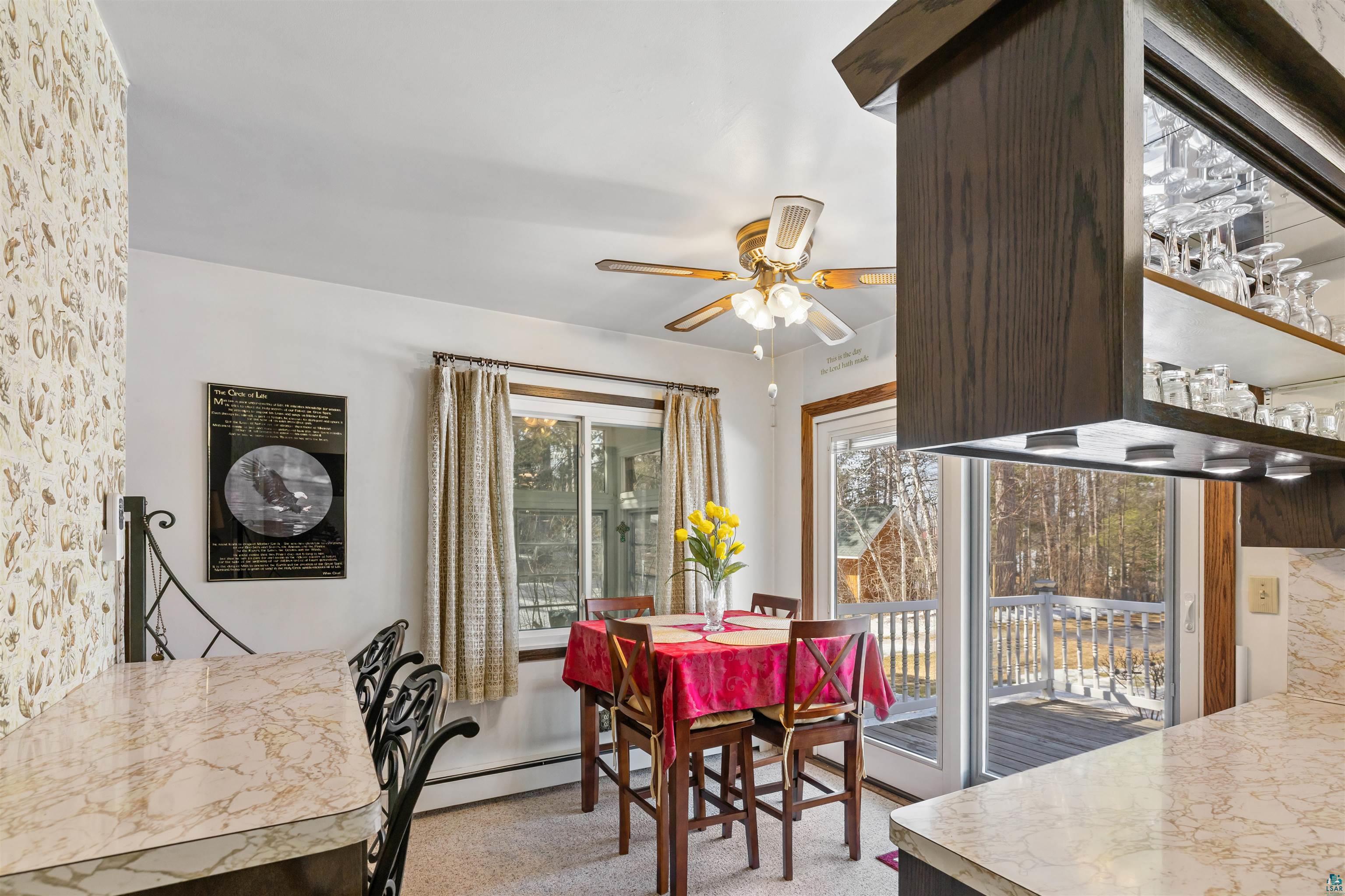 3975 Long Lake Shores Road Eveleth, MN 55734 - Photo 23 of 79 Dining area with a ceiling fan and a baseboard radiator