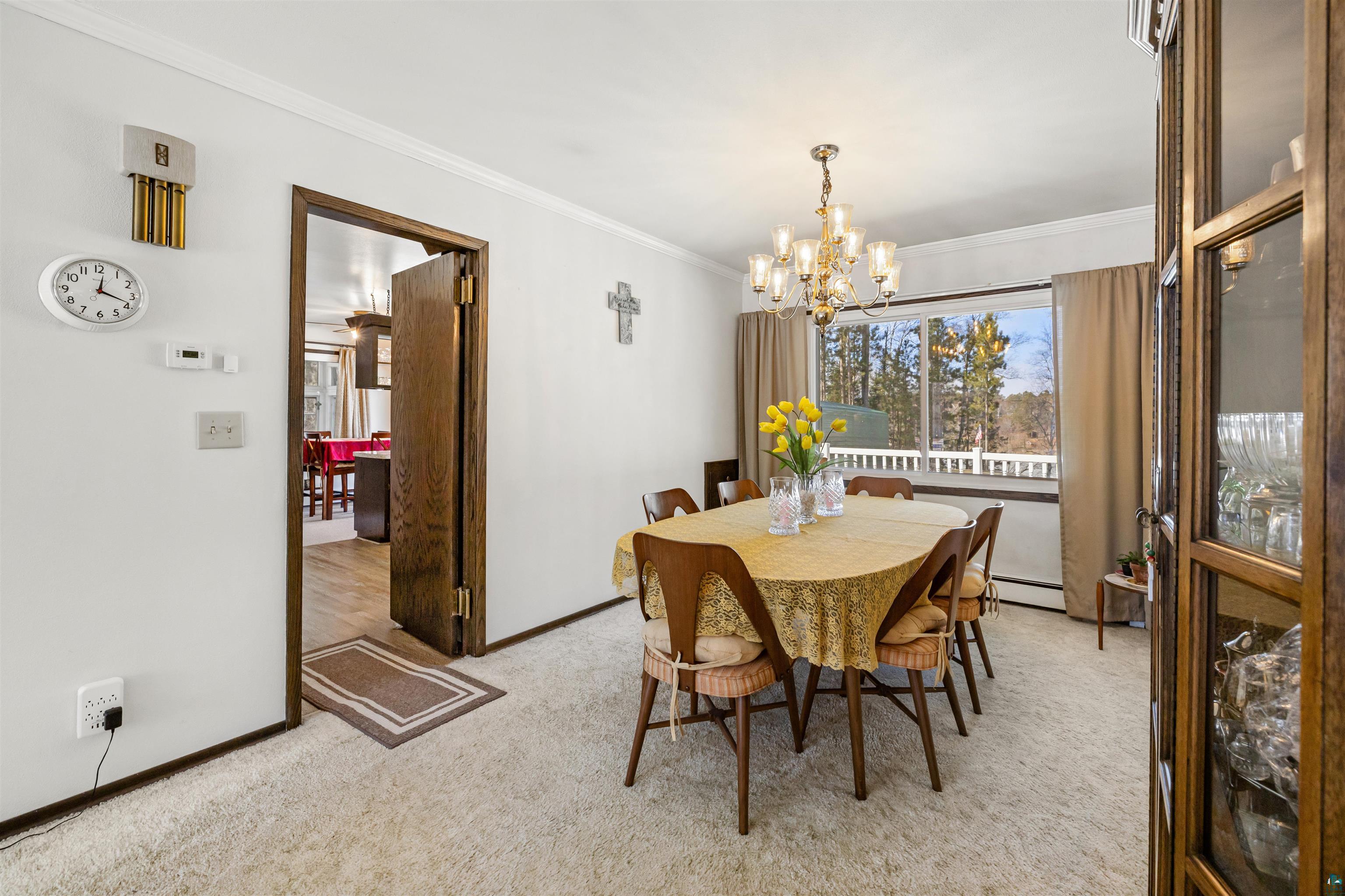 3975 Long Lake Shores Road Eveleth, MN 55734 - Photo 25 of 79 Dining area with ornamental molding, hanging lights, and light colored carpet