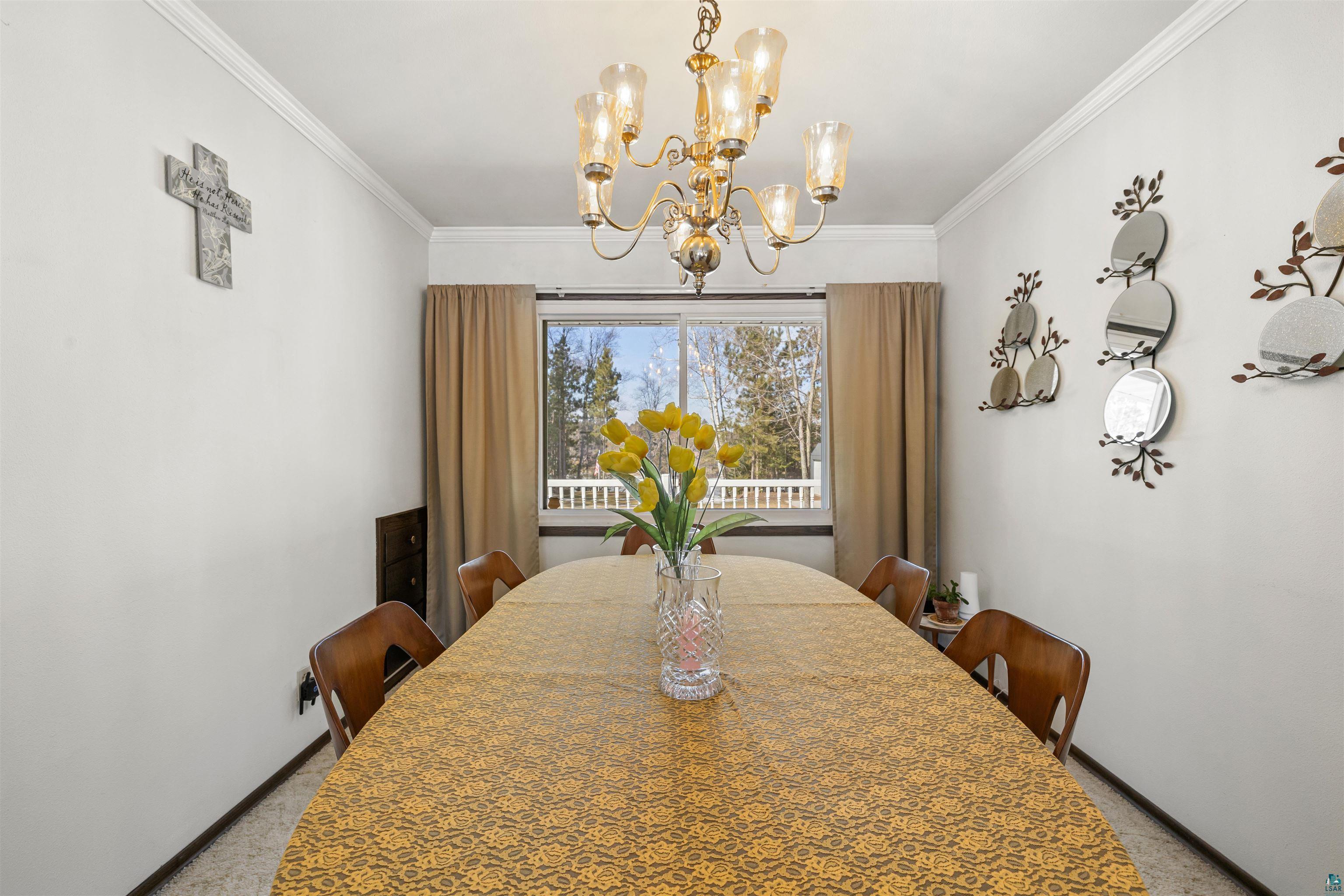 3975 Long Lake Shores Road Eveleth, MN 55734 - Photo 26 of 79 Dining room featuring hanging lights and crown molding