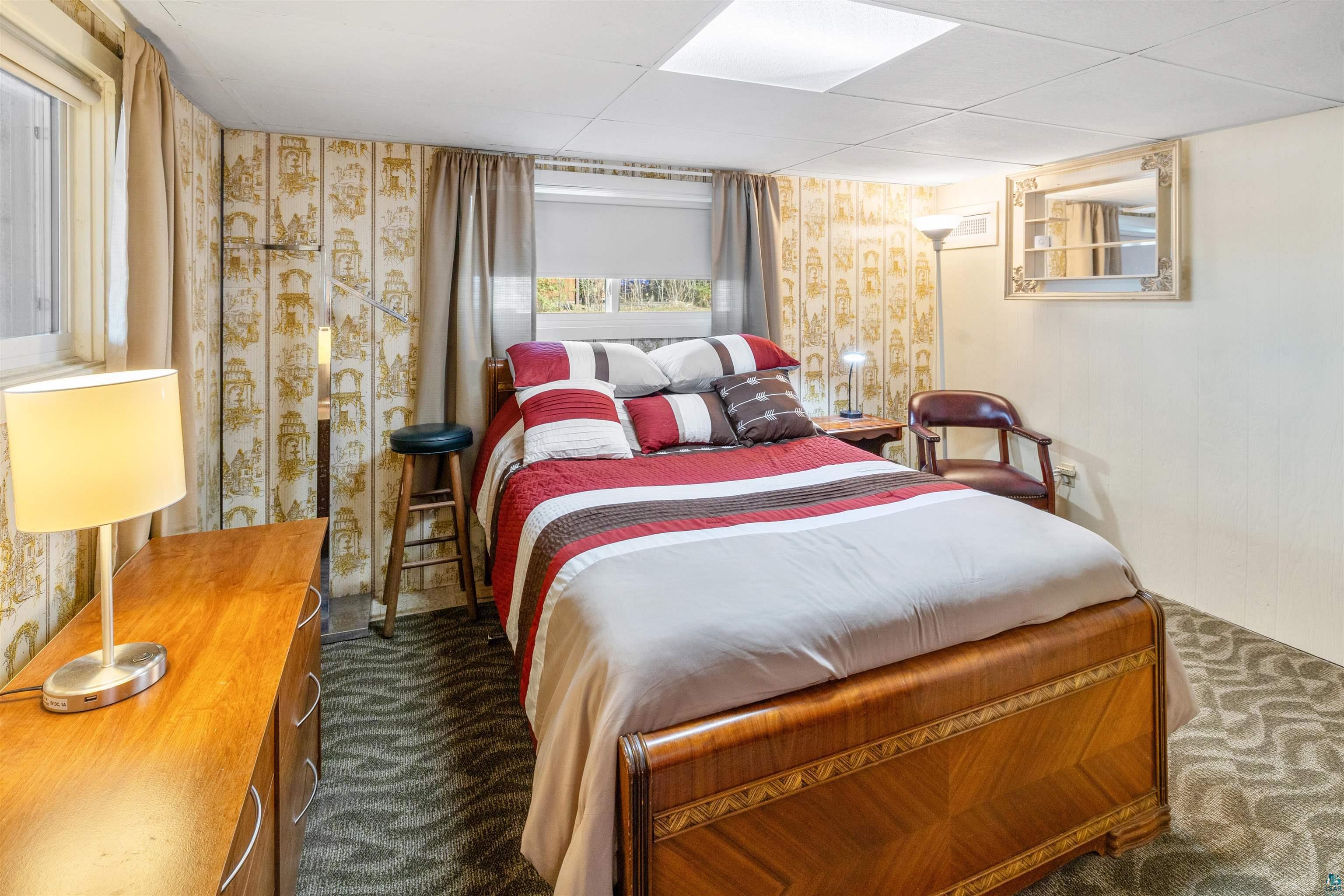 3975 Long Lake Shores Road Eveleth, MN 55734 - Photo 30 of 79 Bedroom featuring wallpapered walls, dark carpet, and a paneled ceiling