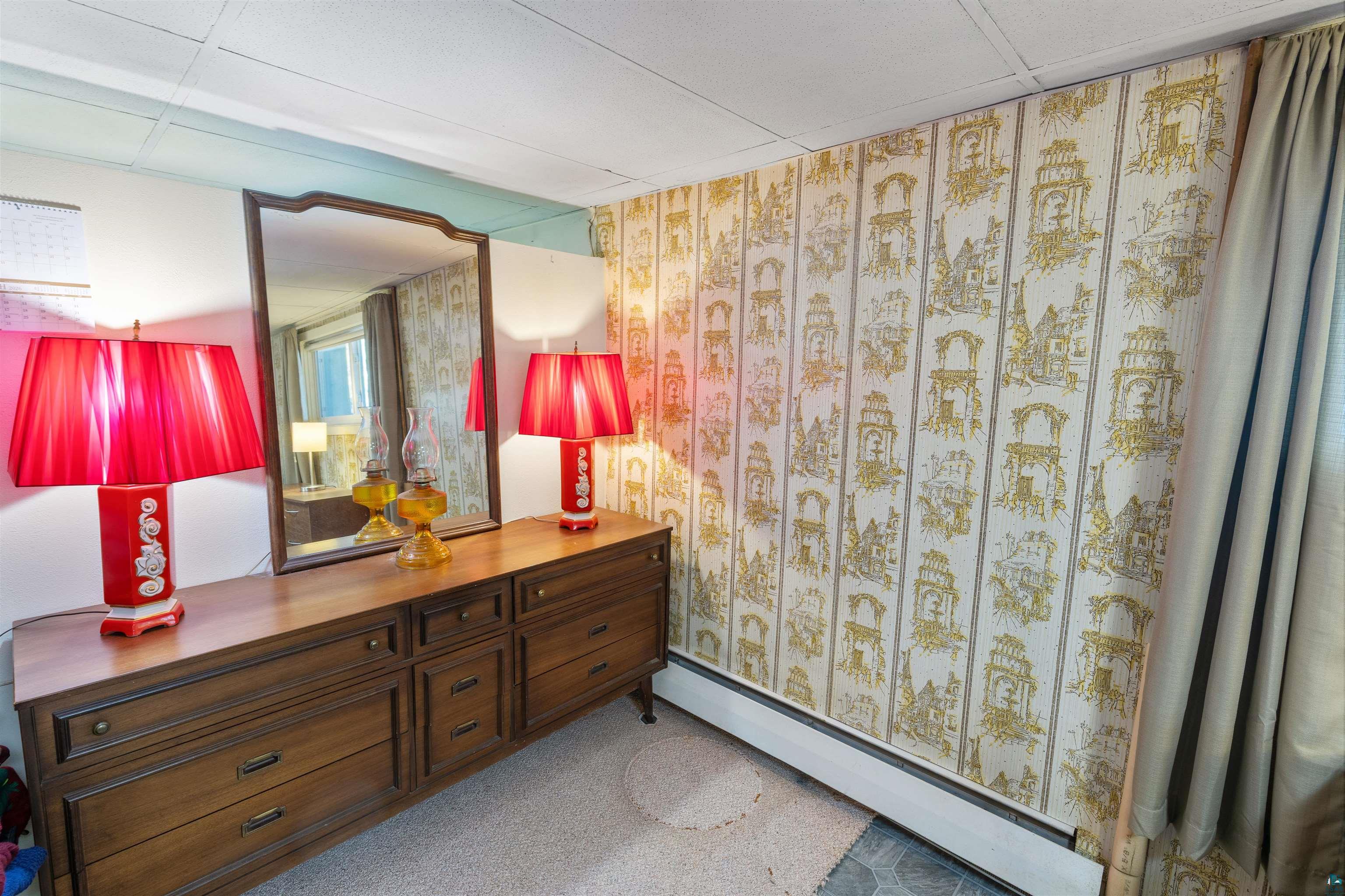 3975 Long Lake Shores Road Eveleth, MN 55734 - Photo 31 of 79 Bathroom featuring baseboard heating, light carpet, and vanity