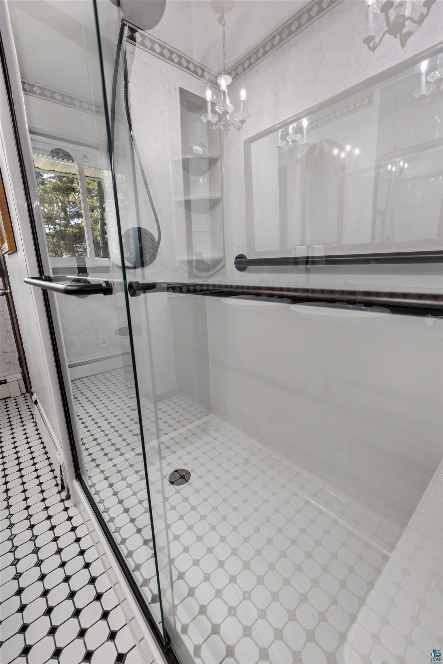 3975 Long Lake Shores Road Eveleth, MN 55734 - Photo 40 of 79 Bathroom featuring a shower stall and a chandelier