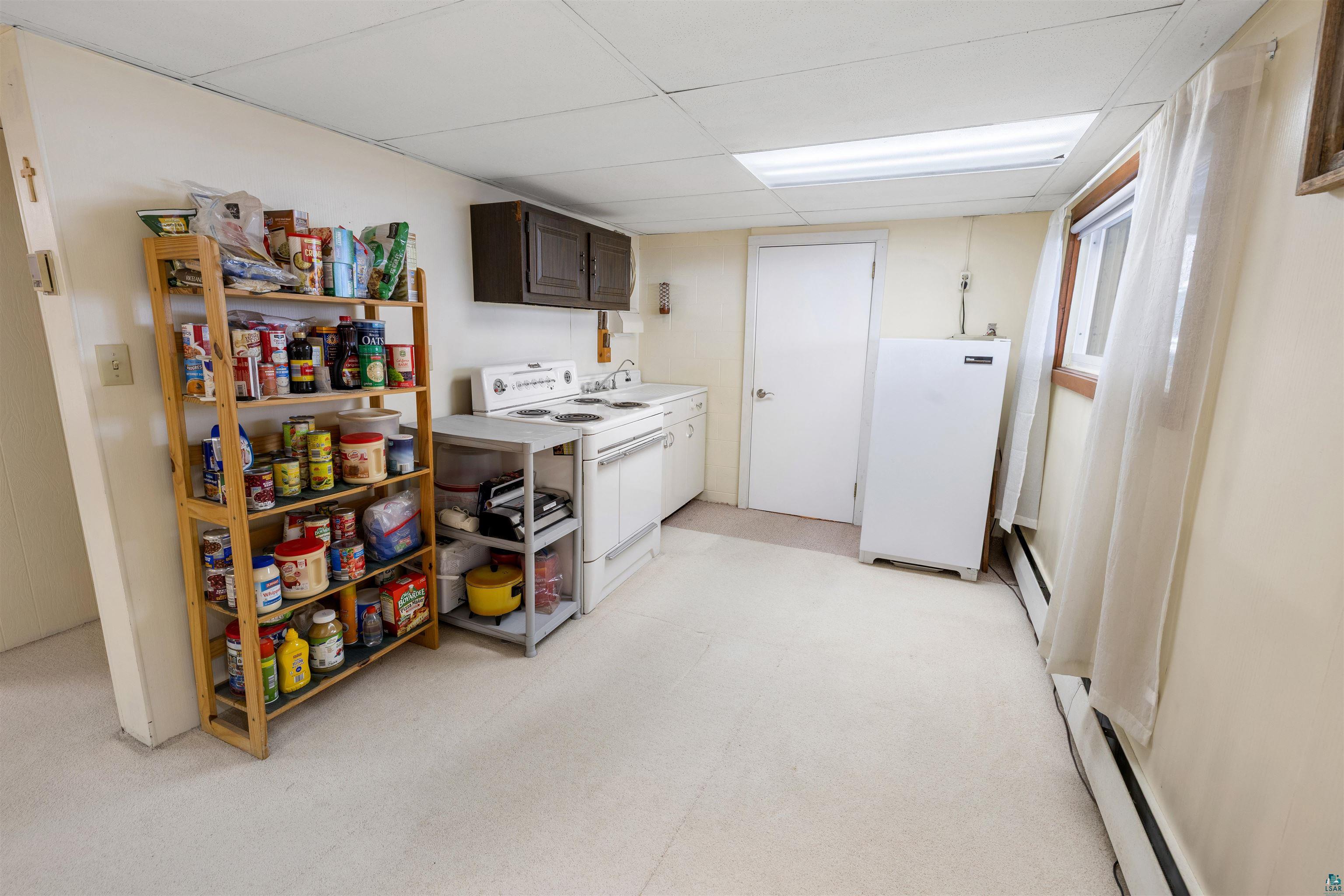 3975 Long Lake Shores Road Eveleth, MN 55734 - Photo 48 of 79 Laundry area featuring a paneled ceiling, light colored carpet, and baseboard heating