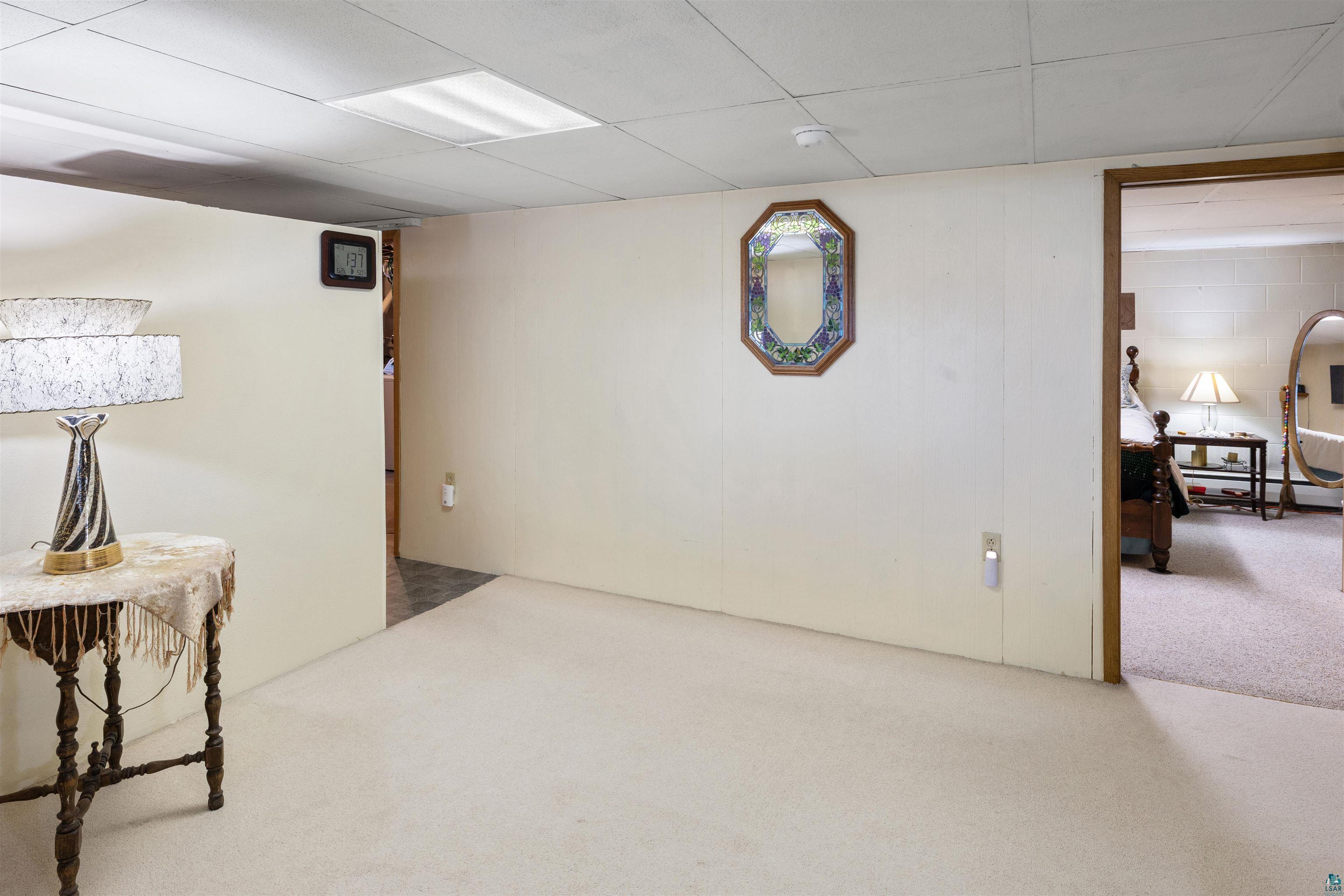 3975 Long Lake Shores Road Eveleth, MN 55734 - Photo 50 of 79 Finished basement featuring carpet floors and a baseboard heating unit