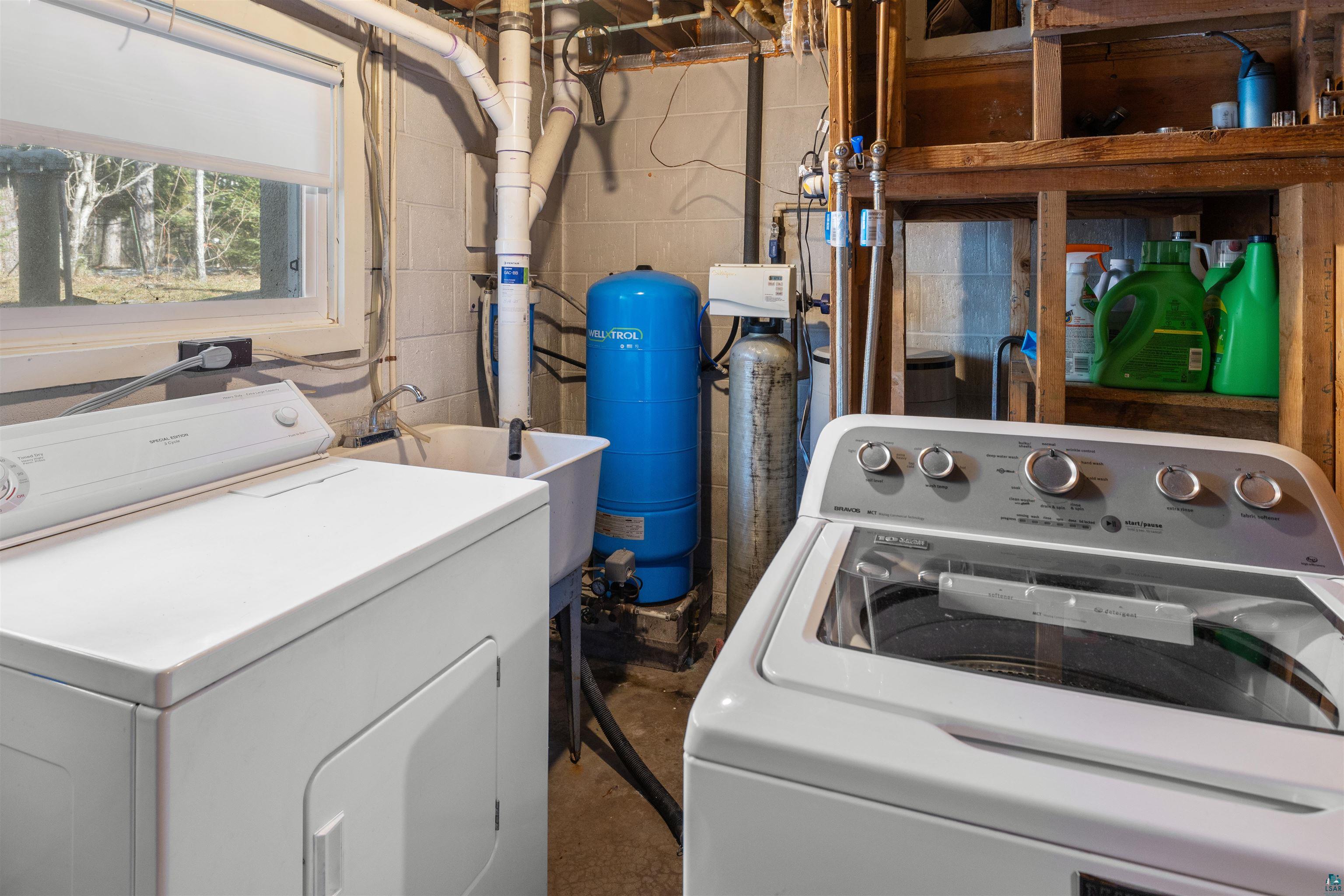 3975 Long Lake Shores Road Eveleth, MN 55734 - Photo 51 of 79 Laundry area with washer and clothes dryer and unfinished concrete flooring