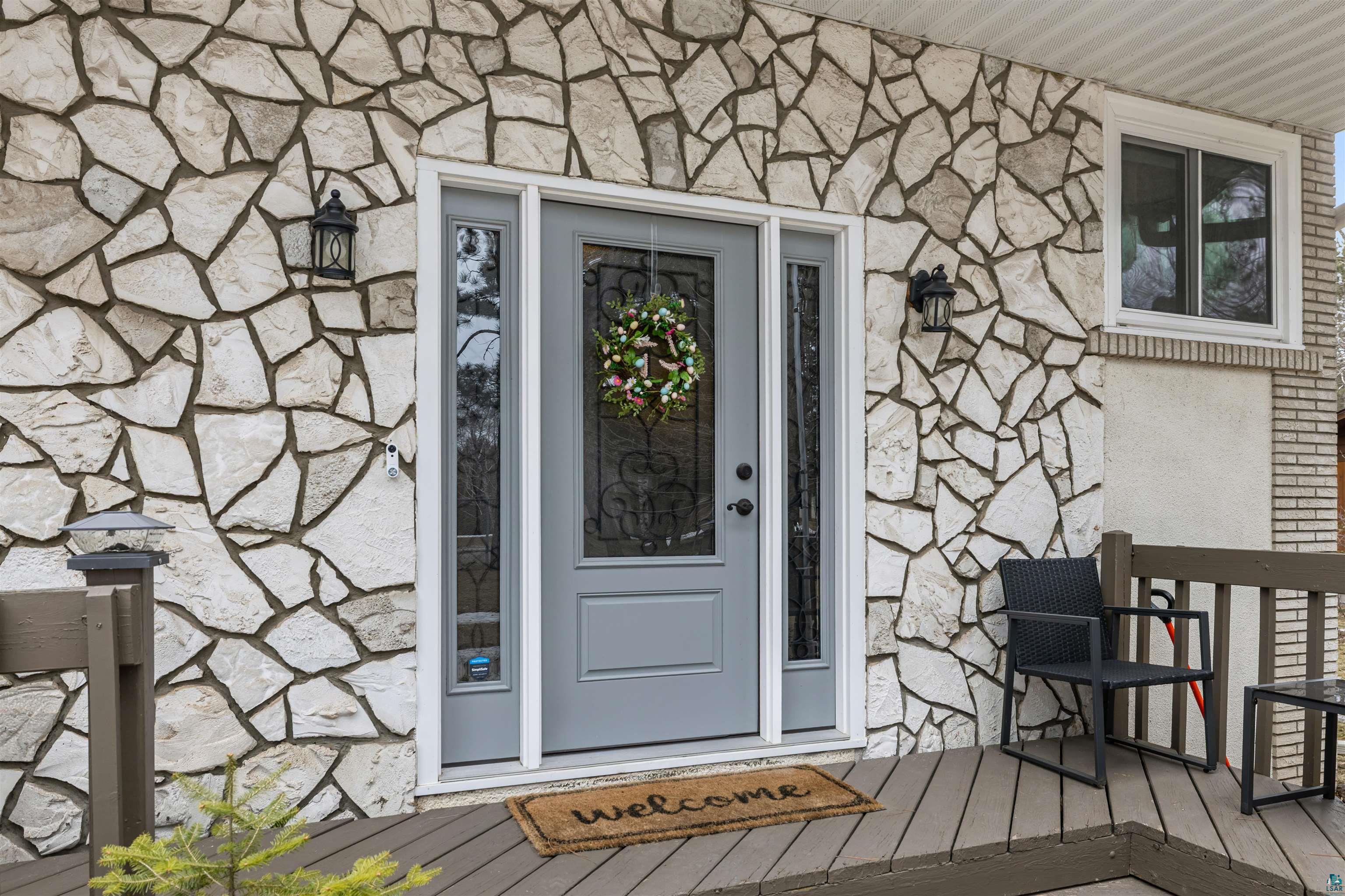 3975 Long Lake Shores Road Eveleth, MN 55734 - Photo 52 of 79 Property entrance featuring stone siding and a deck
