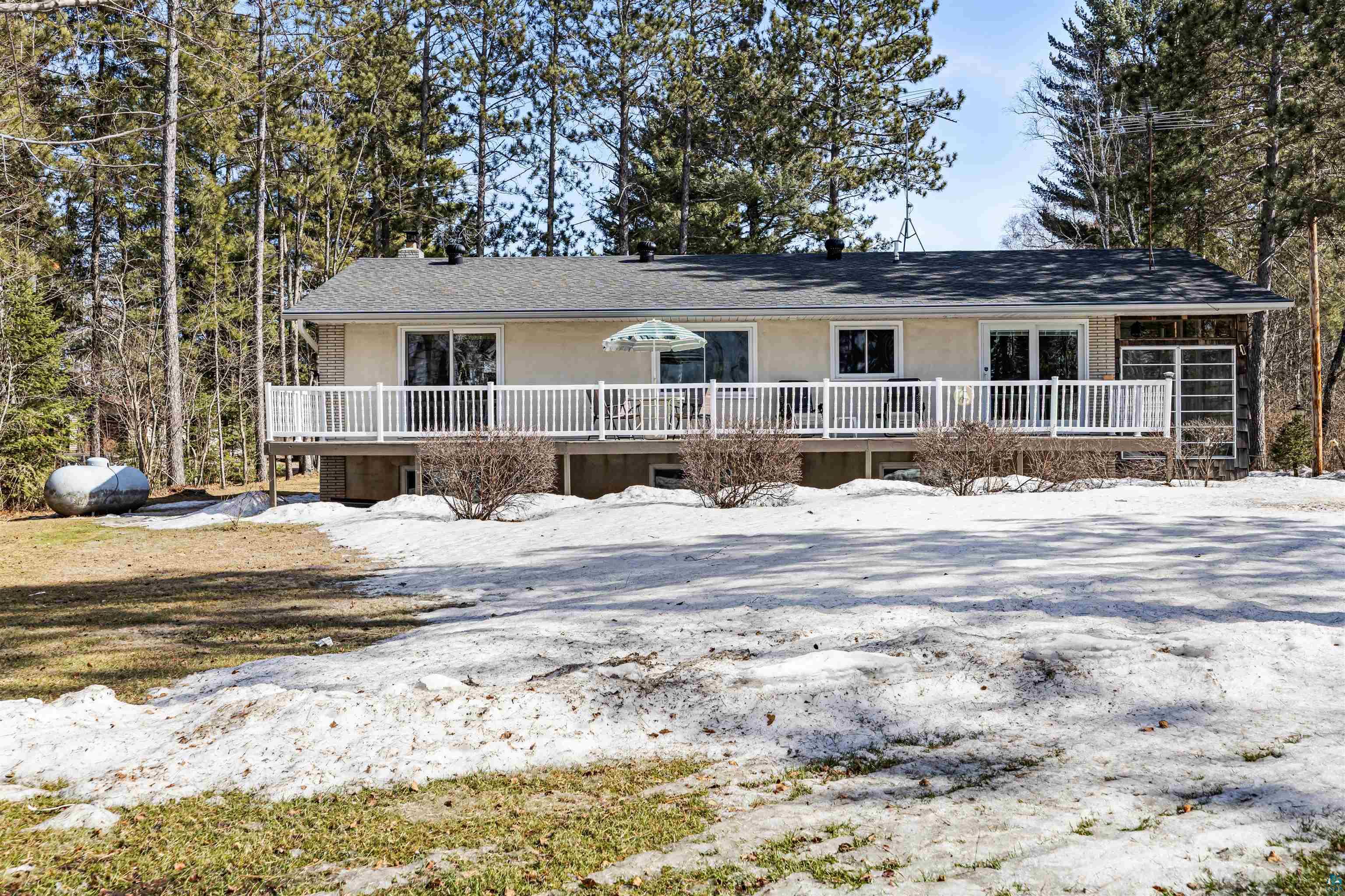 3975 Long Lake Shores Road Eveleth, MN 55734 - Photo 58 of 79 View of front of house with a chimney, stucco siding, and roof with shingles