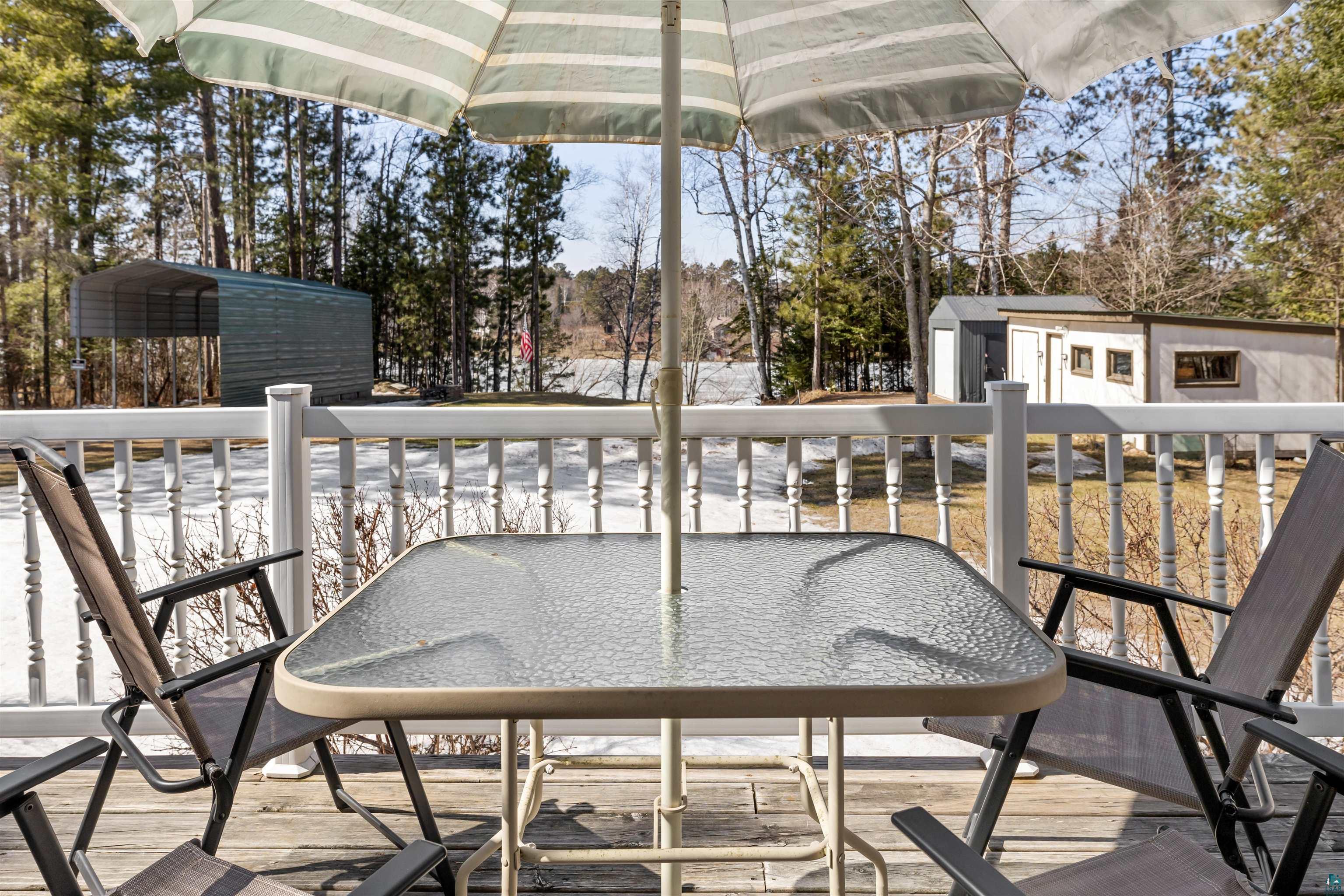 3975 Long Lake Shores Road Eveleth, MN 55734 - Photo 6 of 79 Wooden terrace featuring outdoor dining space and a storage unit