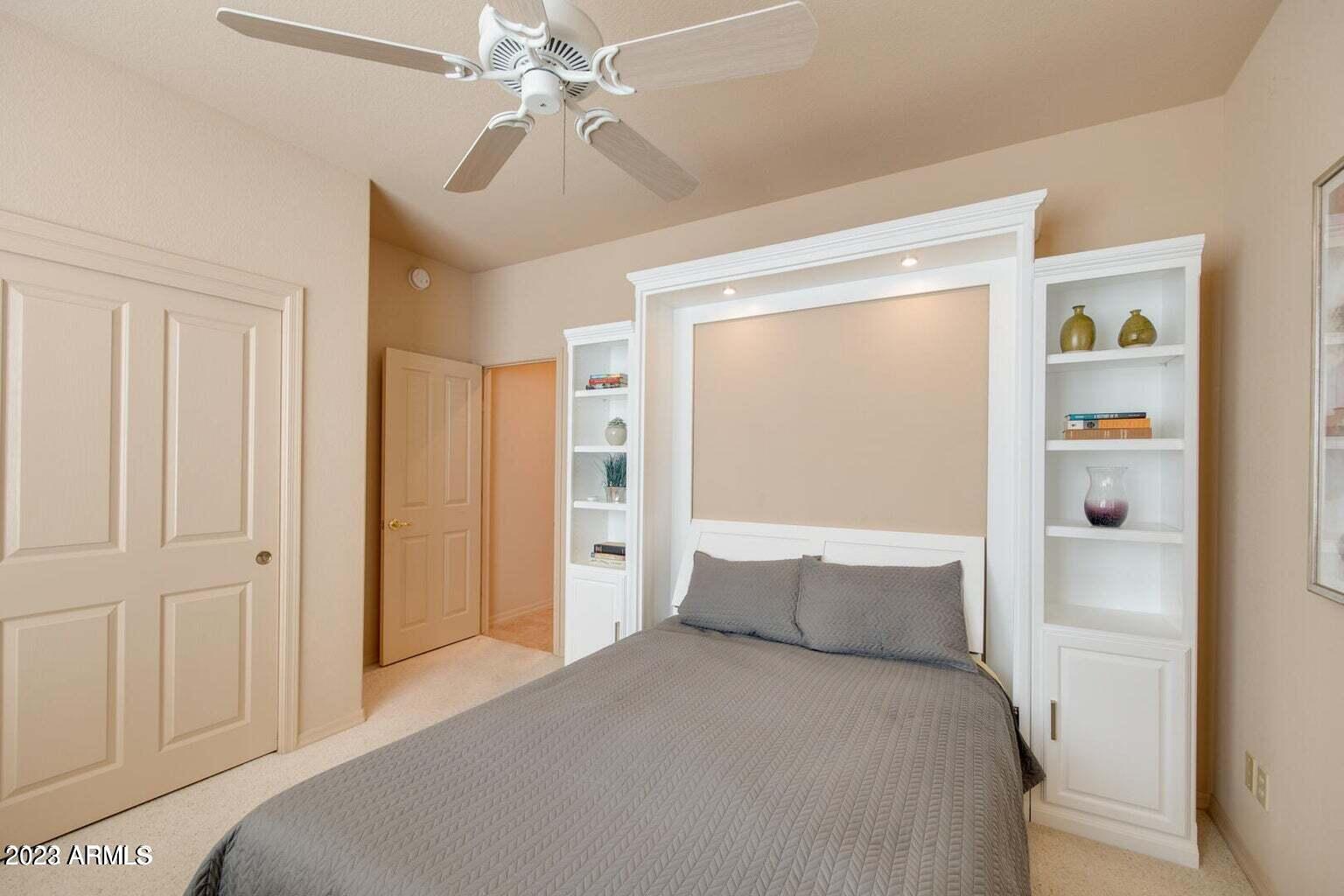 25603 North Sago Drive Rio Verde, AZ 85263 - Photo 11 of 25 a bedroom with a bed and a chandelier
