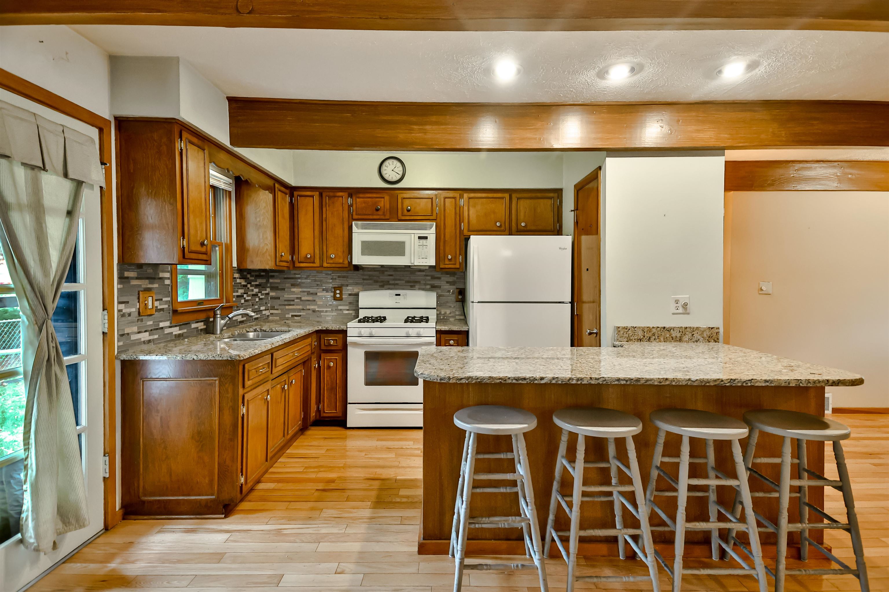 4520 Guilford Road Rockford, IL 61107 - Photo 11 of 28 a kitchen with granite countertop a stove a sink and a refrigerator