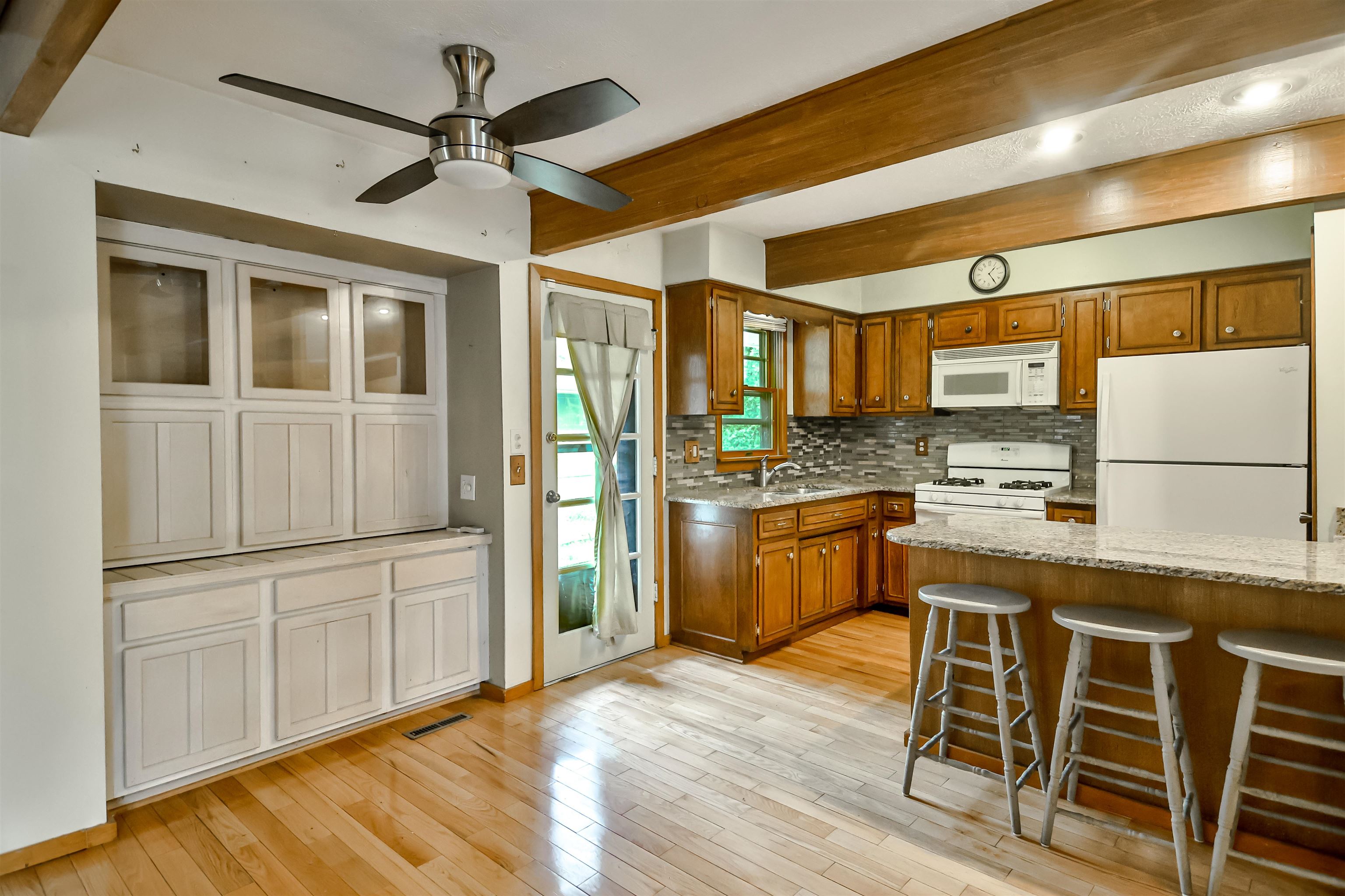 4520 Guilford Road Rockford, IL 61107 - Photo 12 of 28 a kitchen with cabinets and wooden floor